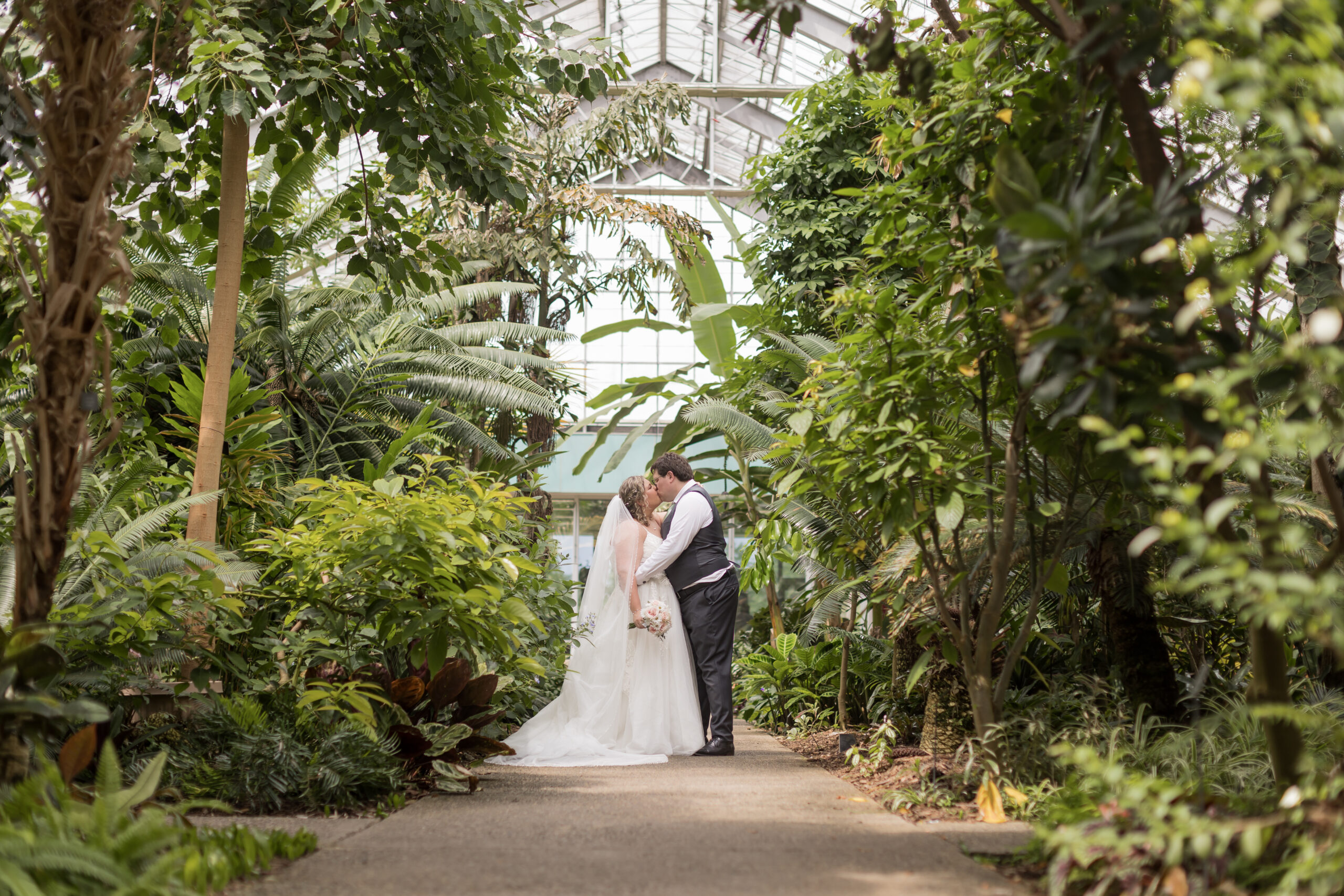 Matthaei Botanical Garden Wedding Bride and Groom Kissing in Greenhouse