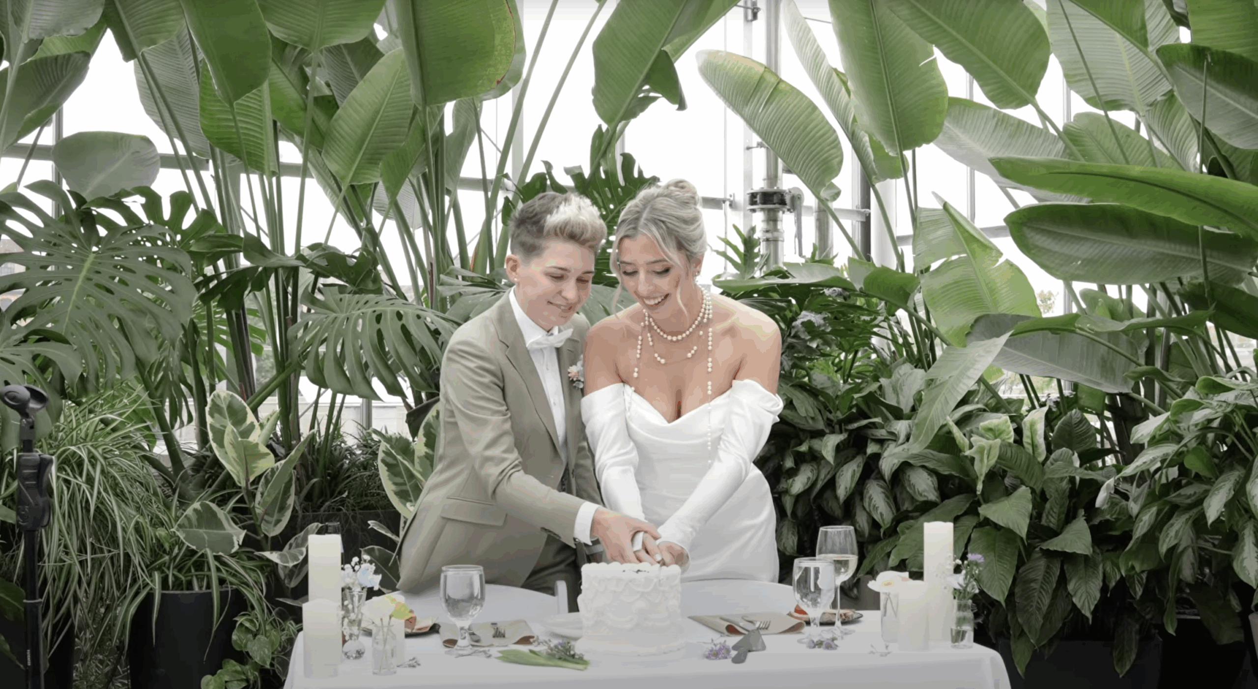 Lesbian brides couple cut cake at wedding in grand rapids downtown market