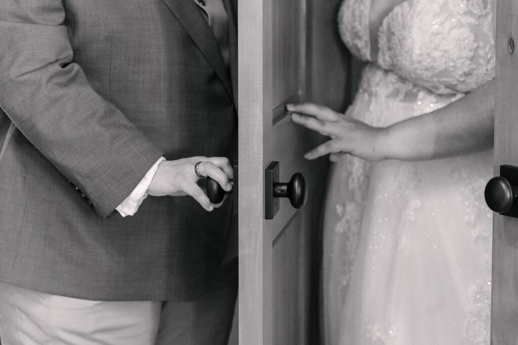 Gentile hands at the door before ceremony.
