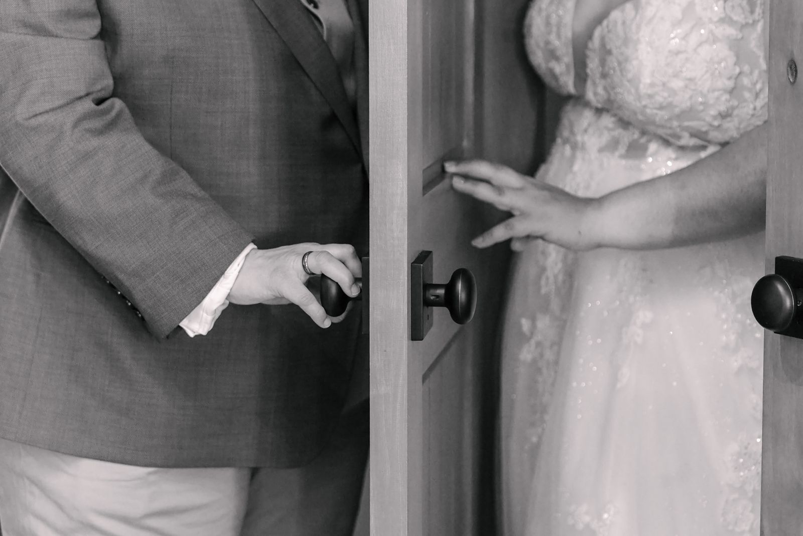 Gentile hands at the door before ceremony.