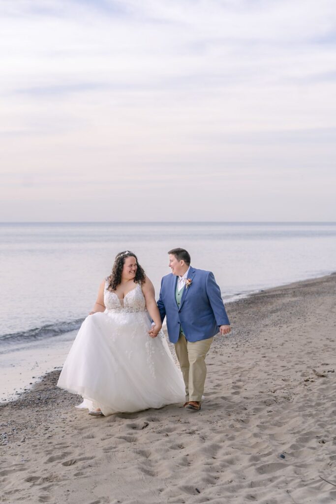 two brides walking on lake michigan shore at lake michigan elopement