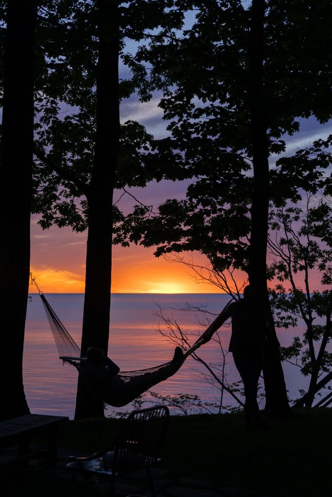 laying in a hammock overlooking amazing lake michigan sunset 